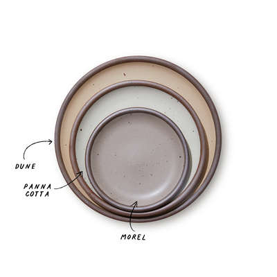 A stack of 3 plates in Dinner, Side, and Cake sizes in a beige, white, and warm pale brown colors.