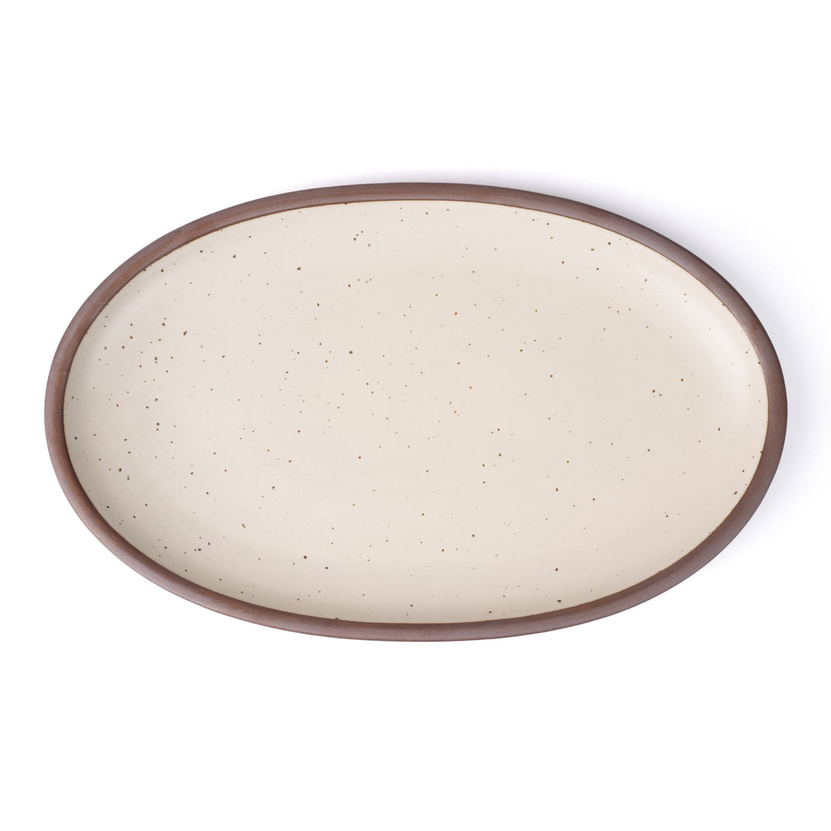 A large oval ceramic platter in a warm off-white color featuring iron speckles and an unglazed rim
