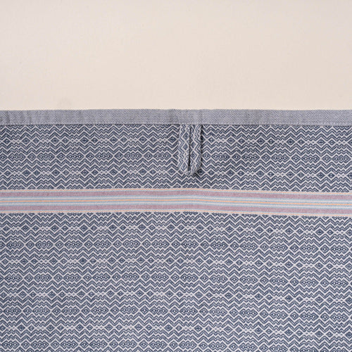 Close-up of a grey woven towel with a zigzag-and-diamond texture, stitched hanging loop, and thin striped band detail.