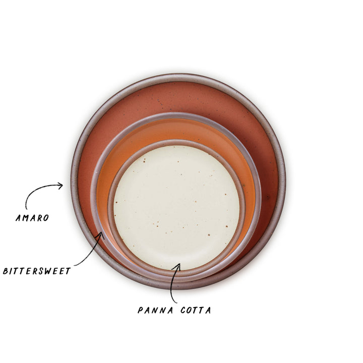Three nested ceramic plates in terra cotta, earthy orange, and soft cream white glazes, shown from a top-down view on a white background with text labels pointing to each color. 
