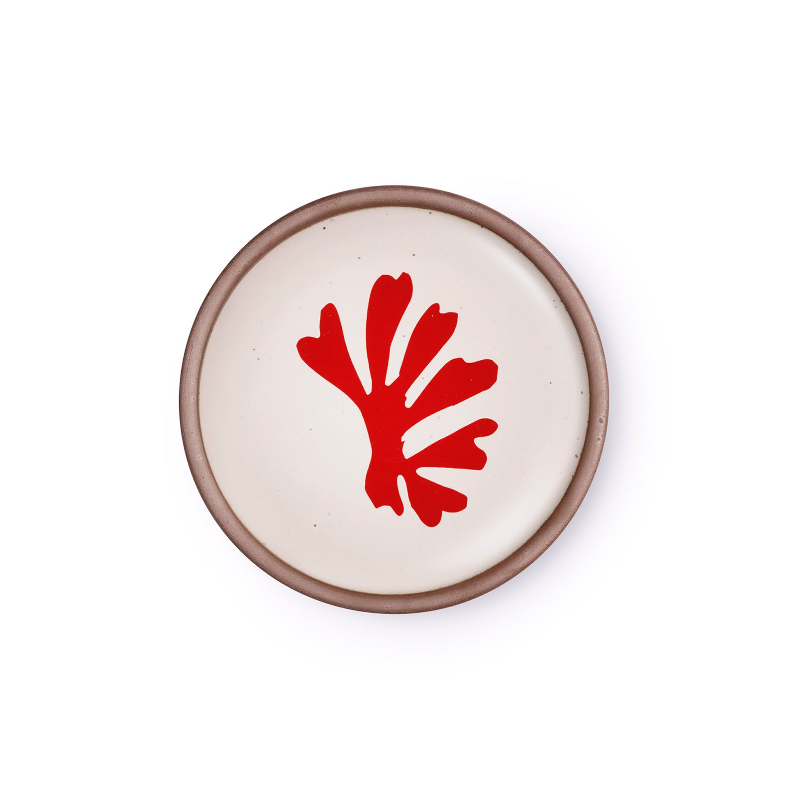 A ceramic dessert sized plates in a warm off-white color with unglazed rim, a frond-like cut-outs from Henri Matisse’s La Perruche et la sirène.