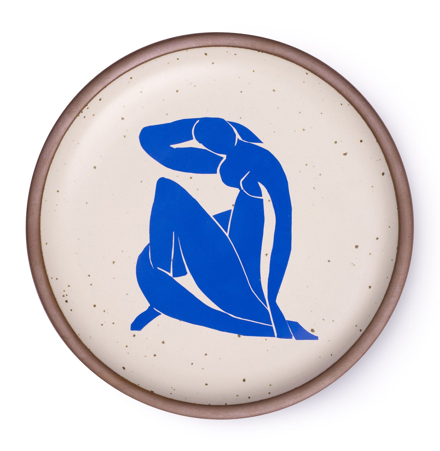A plate featuring Nu Bleu II, by Henri Matisse, a bright blue, abstract, silhouetted female figure in a curled, seated position, with sharp cut-out edges, centered on an off-white ceramic plate with an unglazed rim.