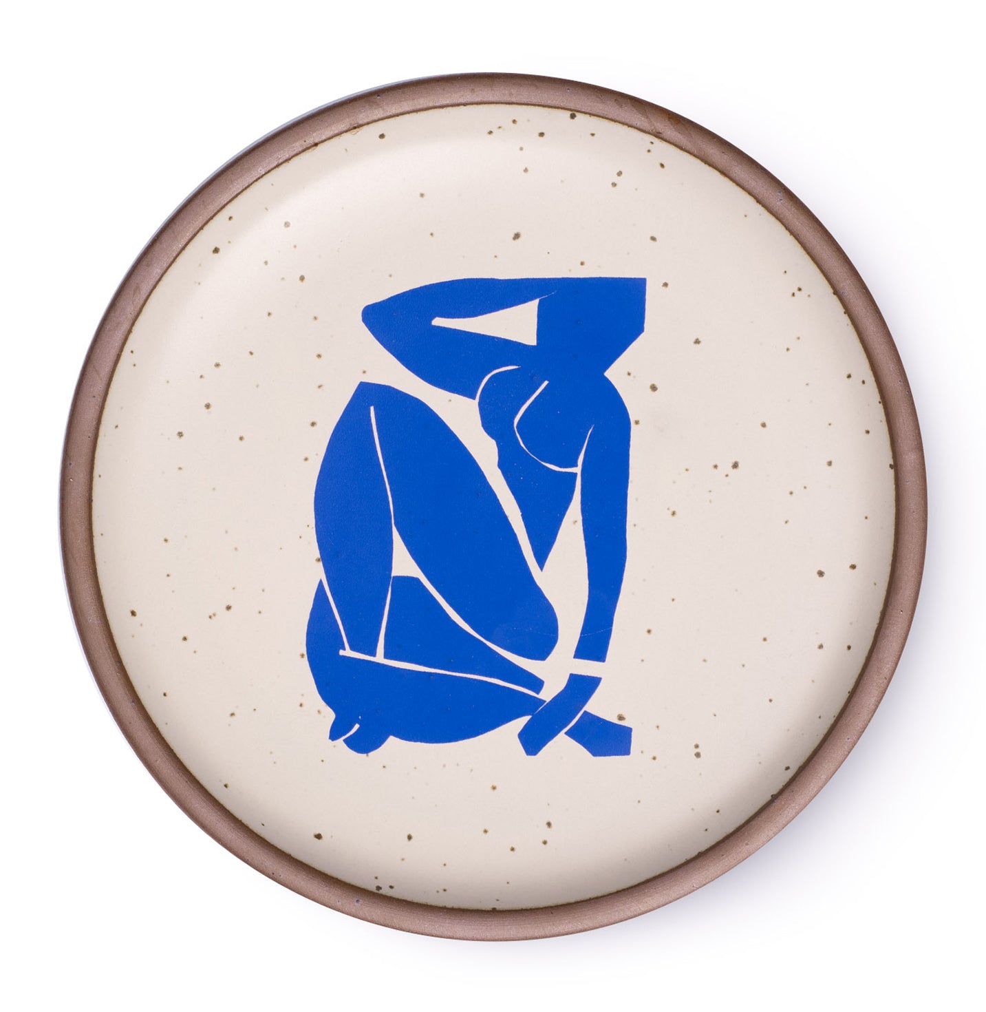 A plate featuring Nu Bleu III, by Henri Matisse, a bright blue, abstract, silhouetted female figure in a curled, seated position, with sharp cut-out edges, centered on an off-white ceramic plate with an unglazed rim.