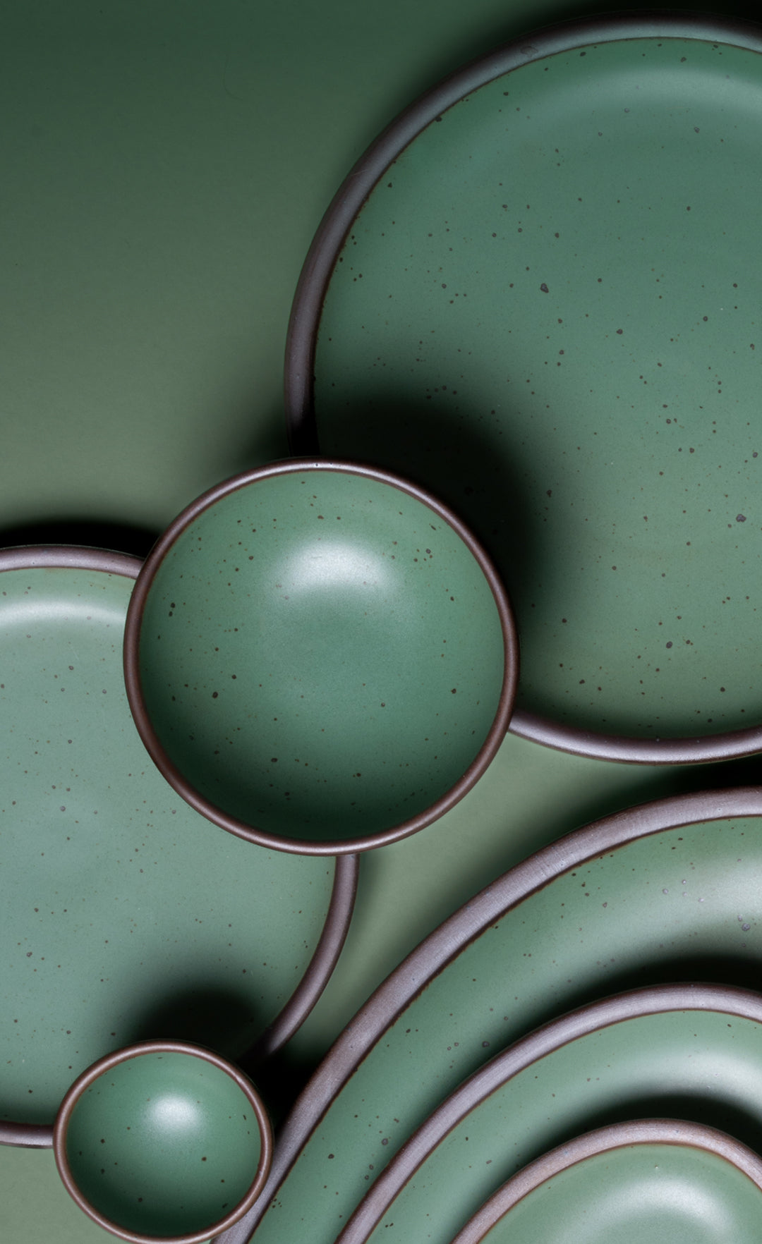 Close-up of green ceramic plates with a matte finish