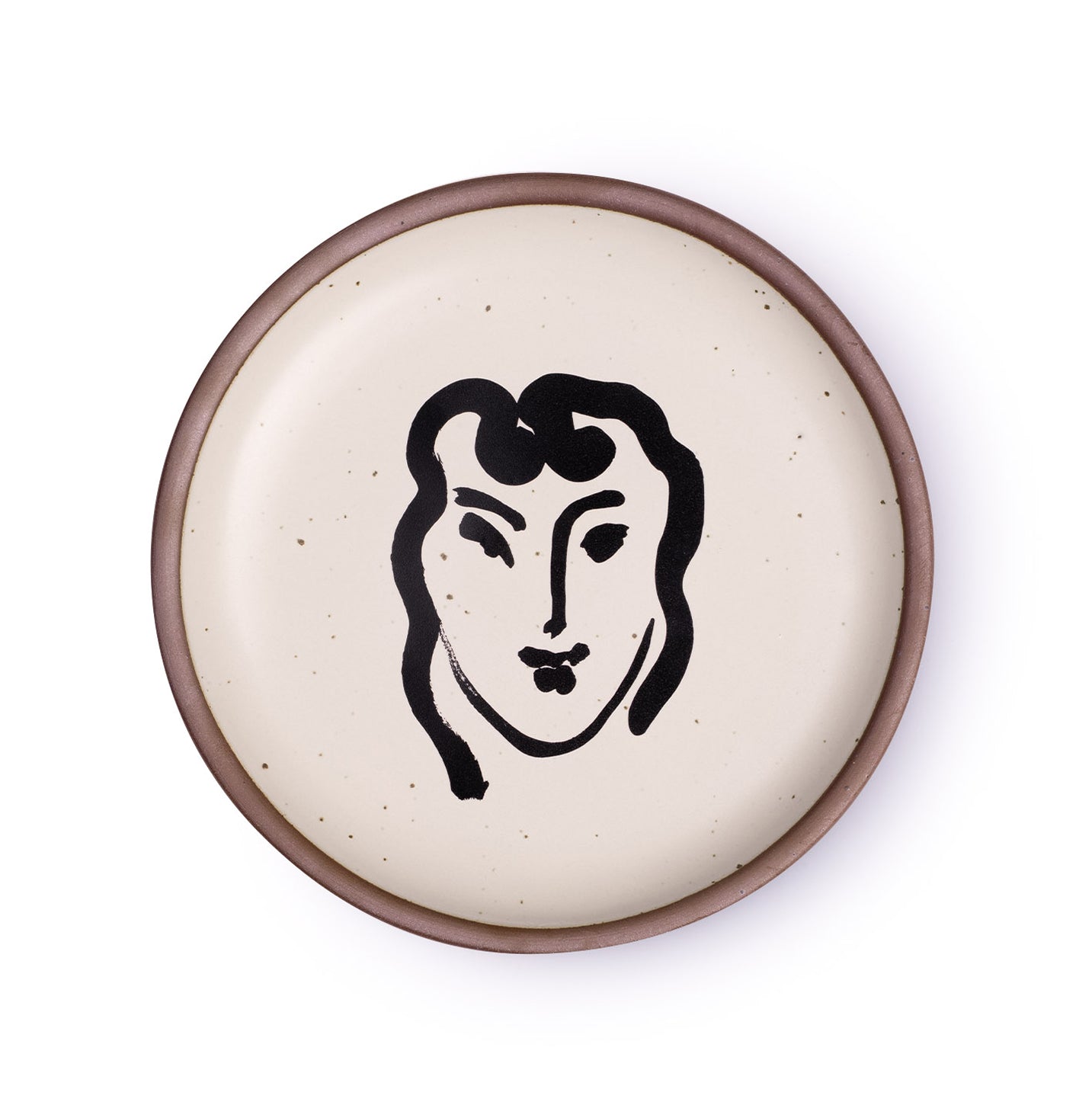 A ceramic plate featuring a decal of the artwork, Patitcha souriante, by Henri Matisse. A minimalist black ink decal of a woman's smiling face in an abstract, expressive style centered on an off-white ceramic plate with an unglazed rim.