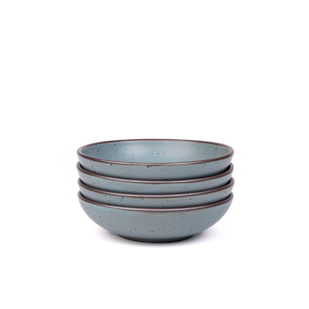 A stack of 4 dinner-sized shallow ceramic bowls in a blue-grey color featuring iron speckles and an unglazed rim