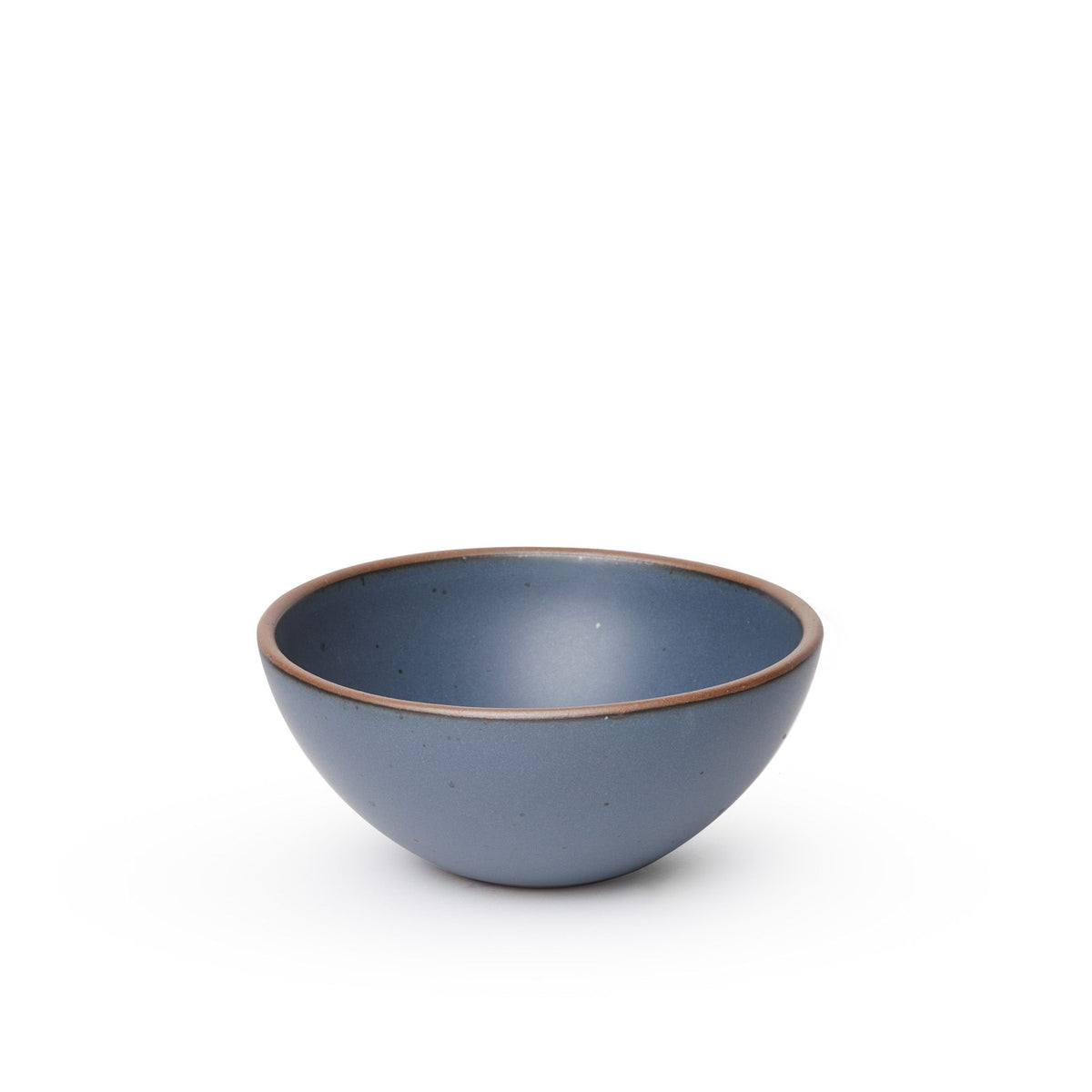 A medium rounded ceramic bowl in a cool, medium blue color featuring iron speckles and an unglazed rim