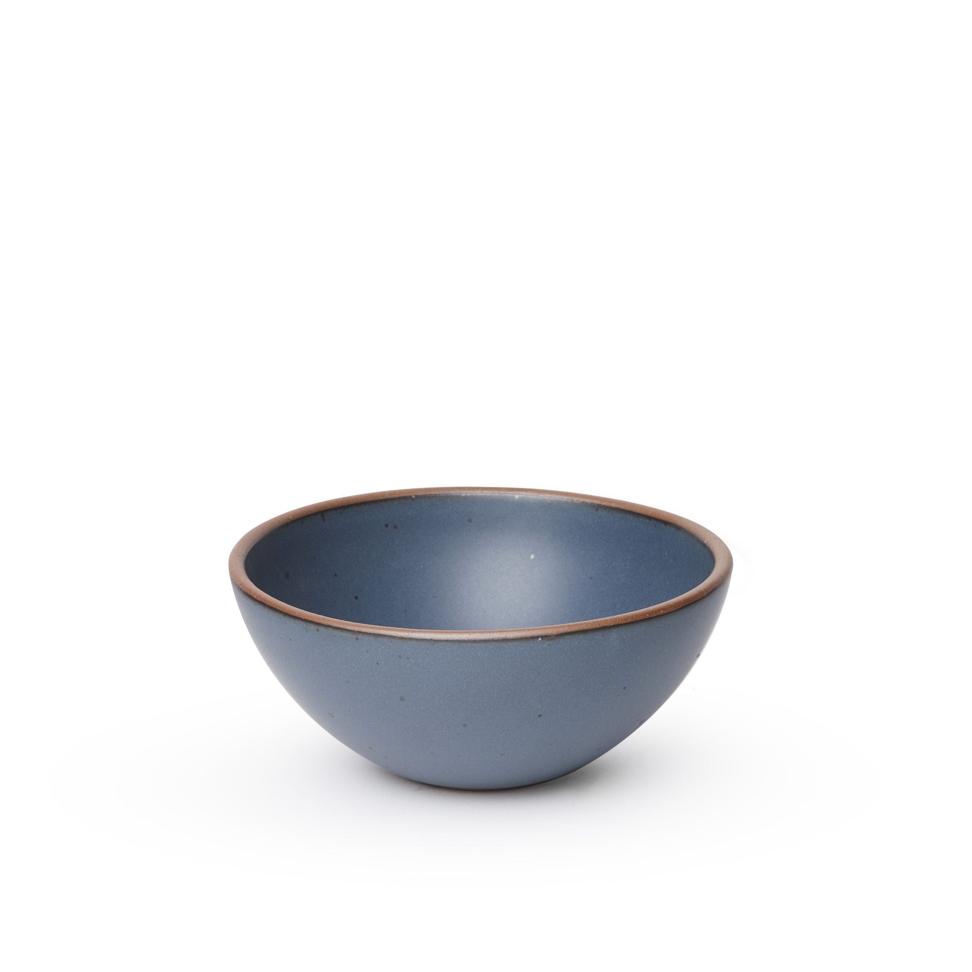 A medium rounded ceramic bowl in a cool, medium blue color featuring iron speckles and an unglazed rim