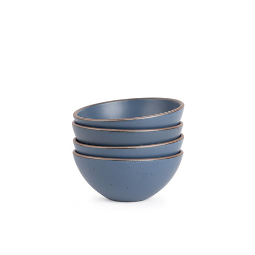 A stack of 4 medium rounded ceramic bowls in a cool, medium blue color featuring iron speckles and an unglazed rim