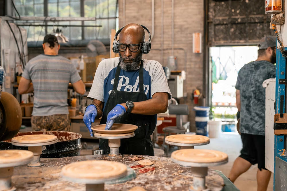 person cleaning rims of bitty bowls by hand