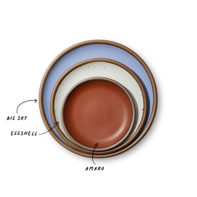 A stack of 3 plates in Dinner, Side, and Cake sizes in a periwinkle, white, and terracotta colors.