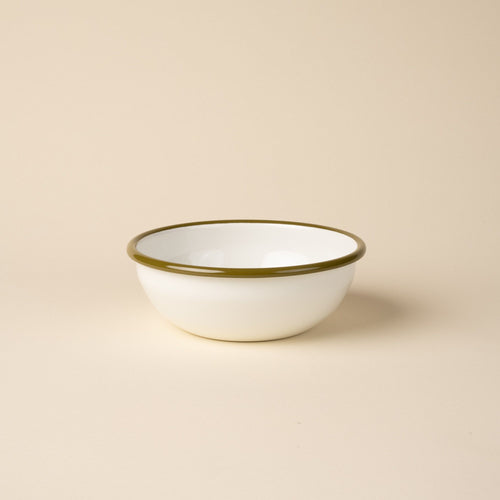 A medium enamel bowl in white with an olive green rim.