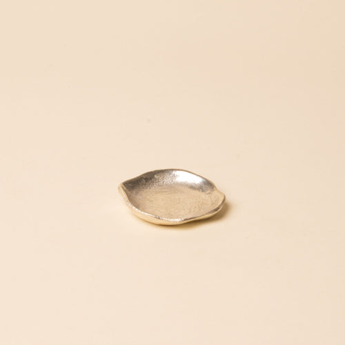 Small round chrome dish with a hammered texture, displayed on a neutral background.