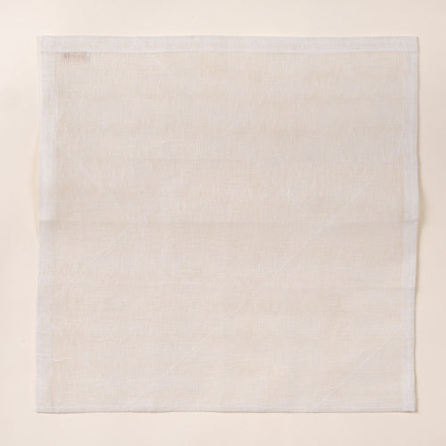 Square white linen cleaning cloth laid flat on a light background, showing a subtle woven texture and stitched edges.