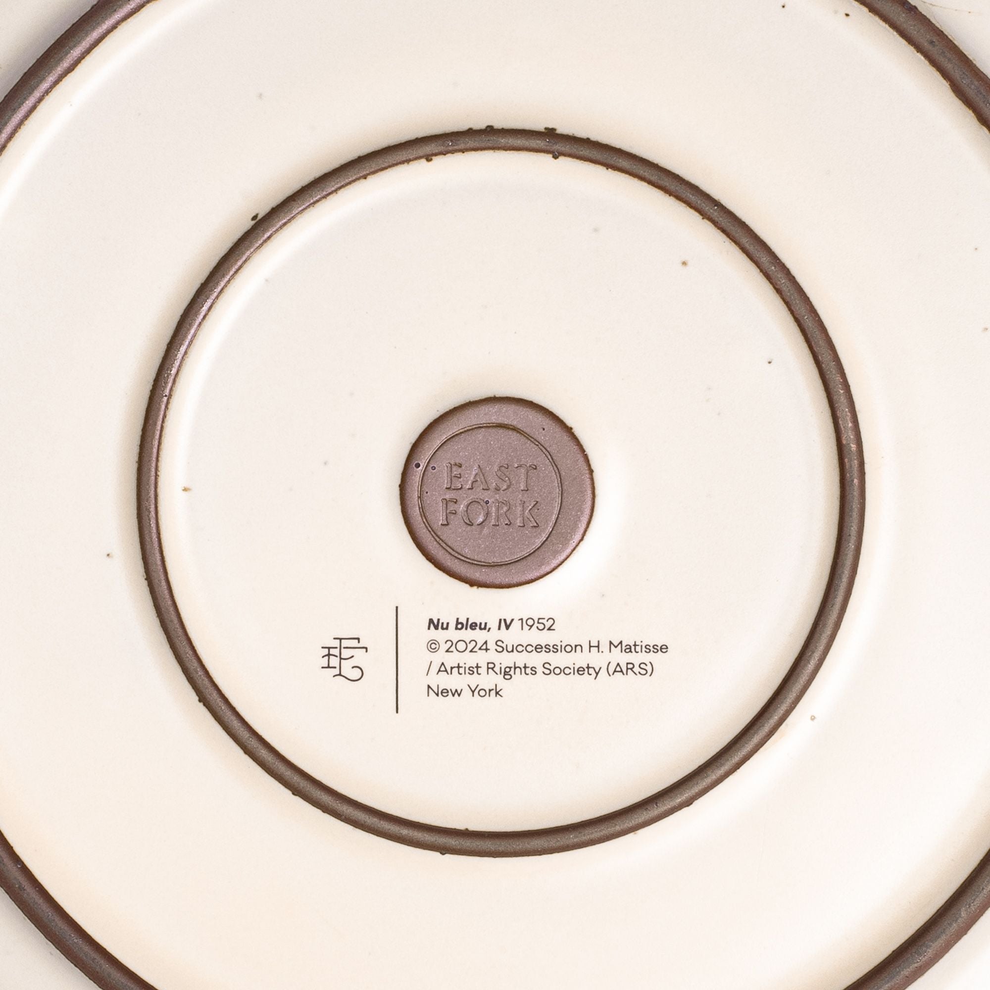 The back of the Dinner Platter with an East Fork stamp with a small decal of information about the artwork.