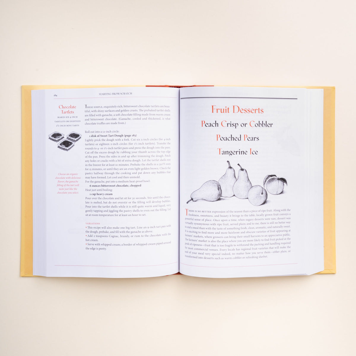 Open cookbook "The Art of Simple Food" by Alice Waters, showing a chocolate tart recipe on the left page and fruit dessert ideas on the right.