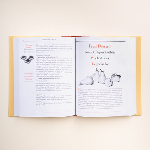 Open cookbook "The Art of Simple Food" by Alice Waters, showing a chocolate tart recipe on the left page and fruit dessert ideas on the right.