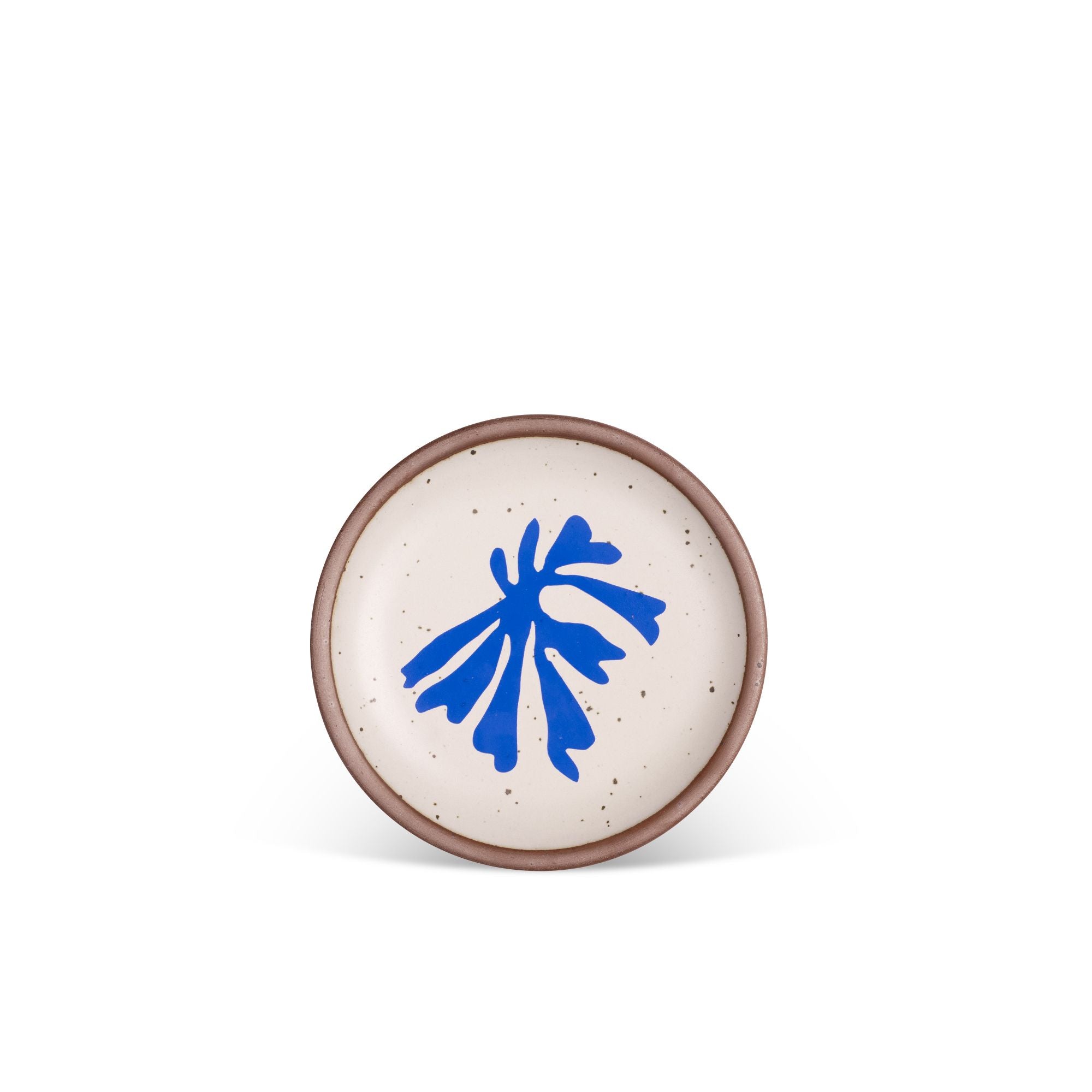 A ceramic dessert sized plates in a warm off-white color with unglazed rim, a frond-like cut-outs from Henri Matisse’s La Perruche et la sirène.