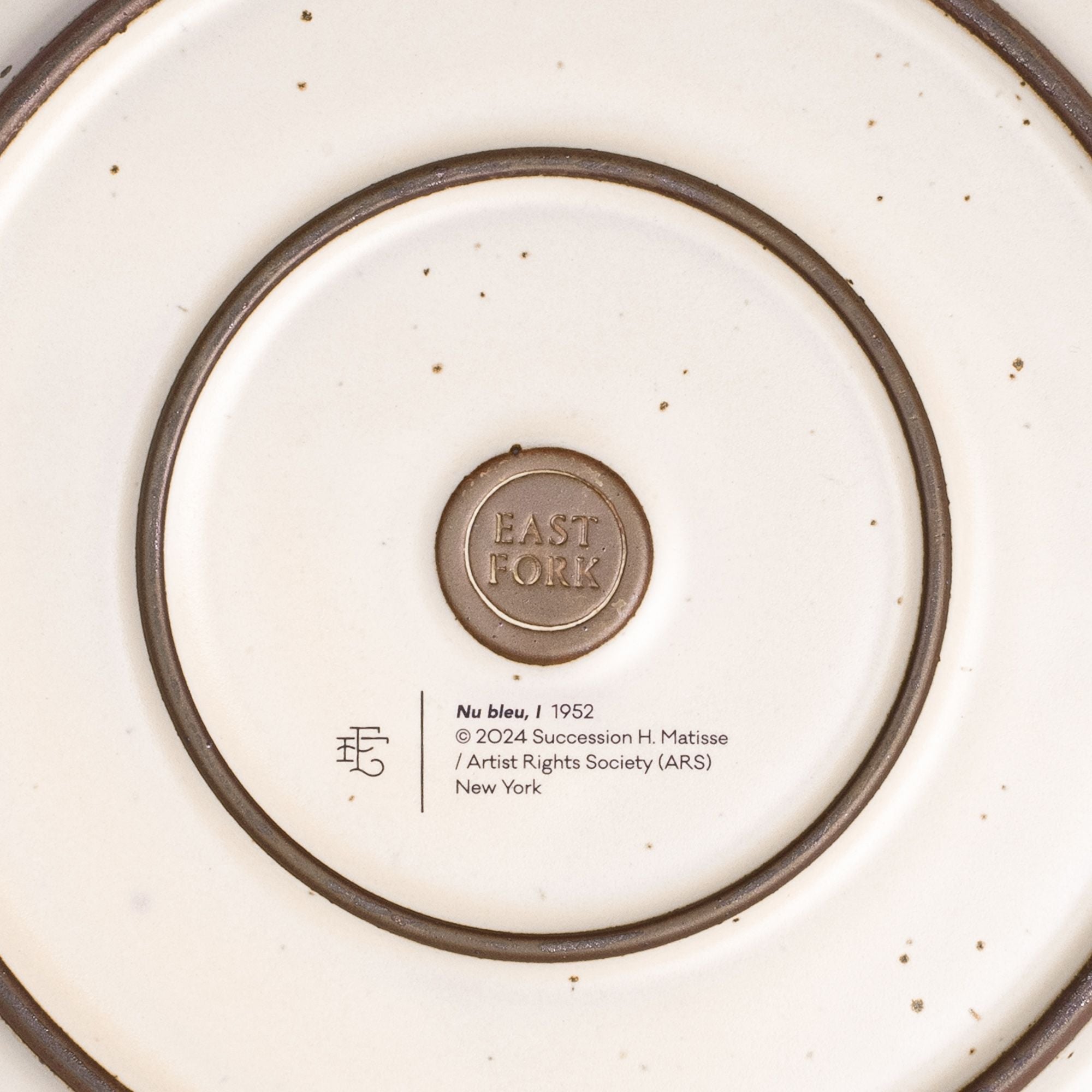The back of the Dinner Platter with an East Fork stamp with a small decal of information about the artwork.
