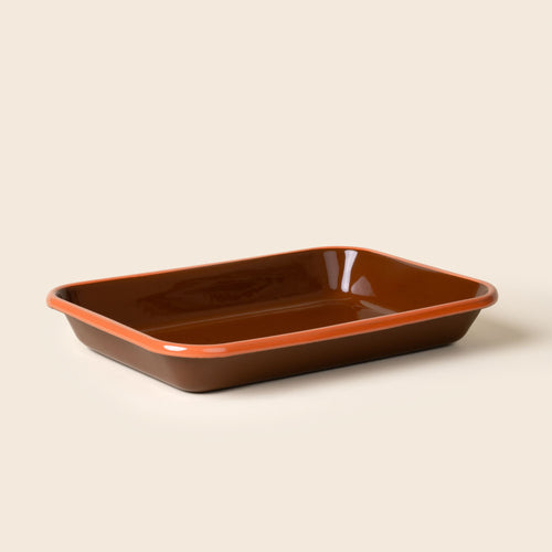 Large rectangular baking dish in a dark red-brown color with an orange rim.