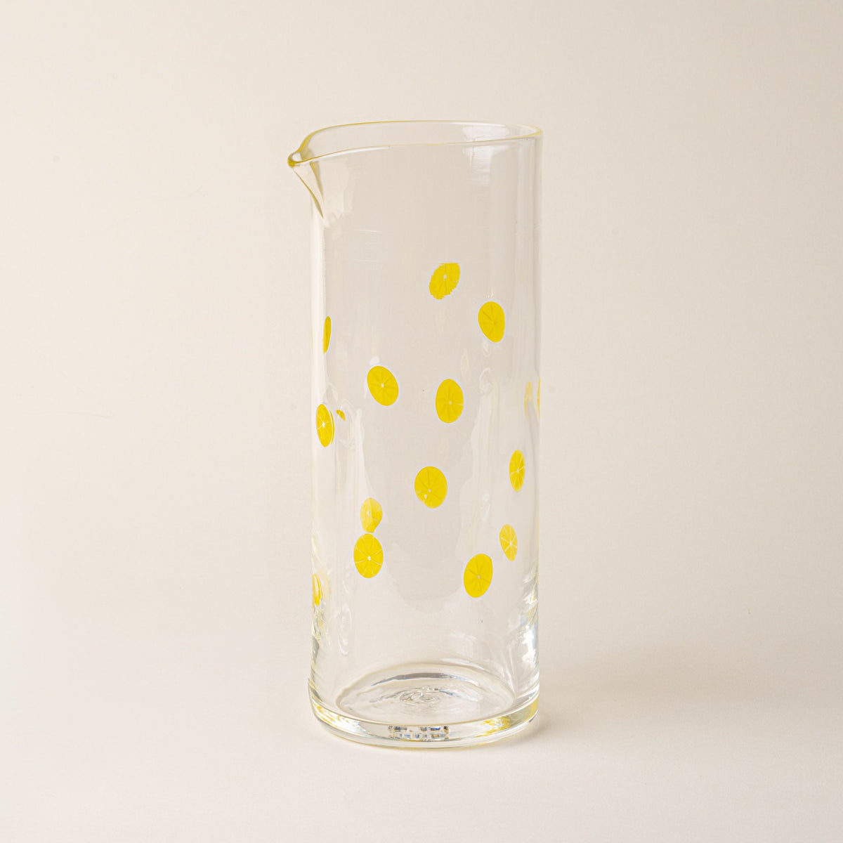 Clear glass pitcher with yellow lemon slice motif and pour spout.