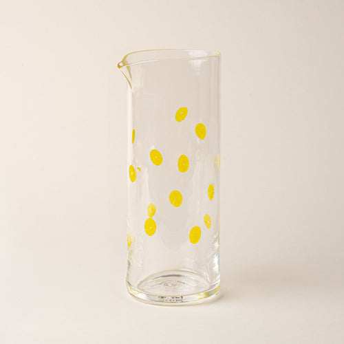 Clear glass pitcher with yellow lemon slice motif and pour spout.
