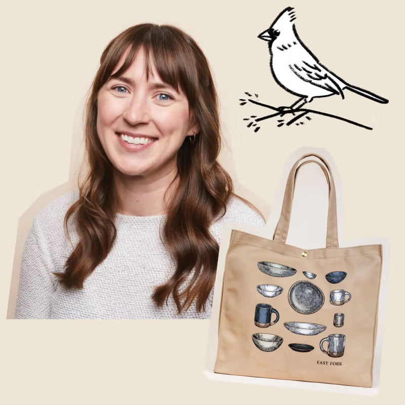 A smiling person with long brown hair and a white sweater is next to a beige canvas tote bag featuring illustrations of pottery items. In the top right corner, there is a simple black line drawing of a bird perched on a branch.