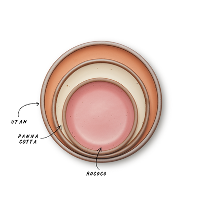 A stack of 3 plates in Dinner, Side, and Cake sizes in a peach, warm off-white, and pink colors.