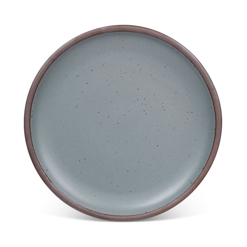 A large ceramic platter in a blue-grey color featuring iron speckles and an unglazed rim