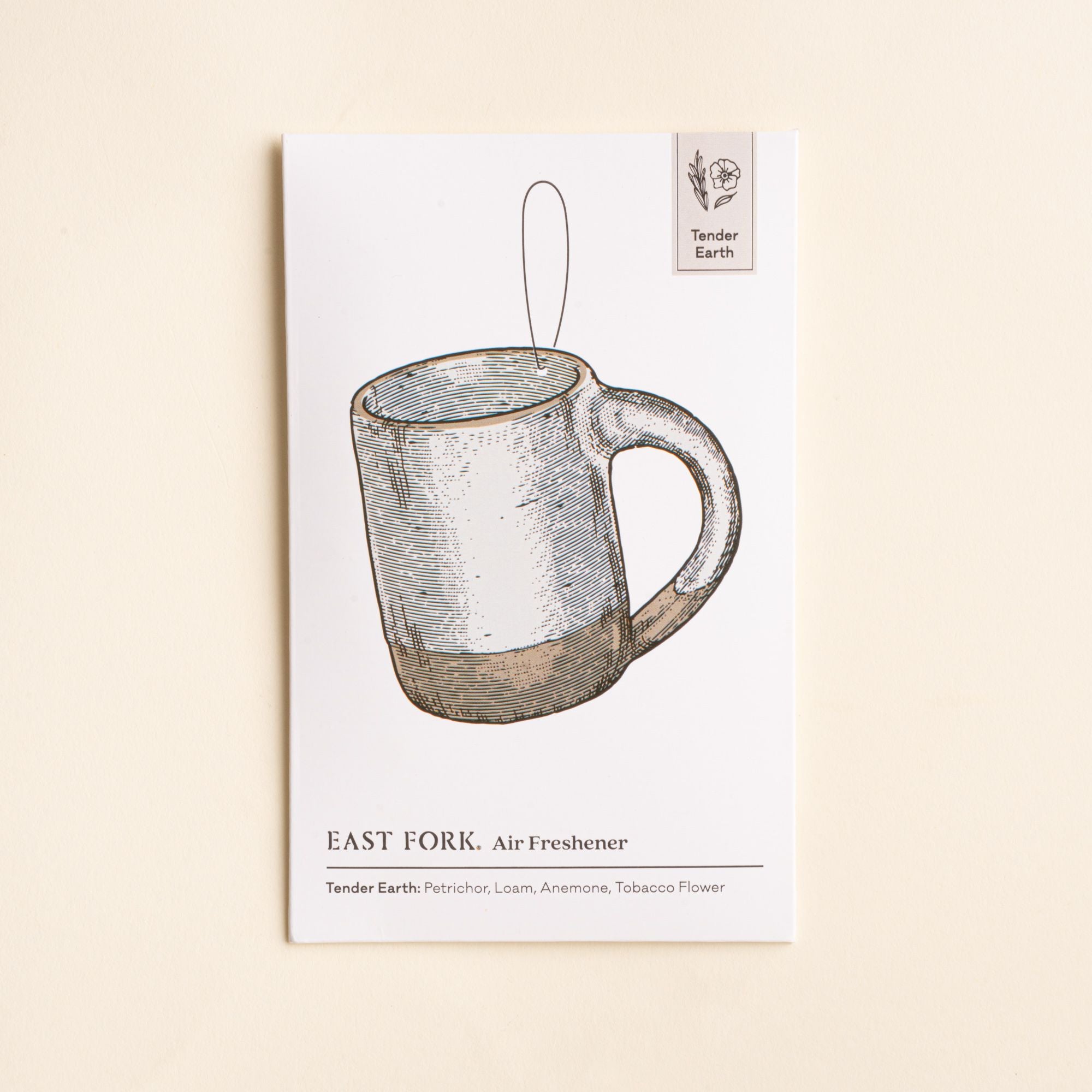 East Fork “Tender Earth” air freshener packaging featuring an illustrated white mug and scent notes of petrichor, loam, anemone and tobacco flower.