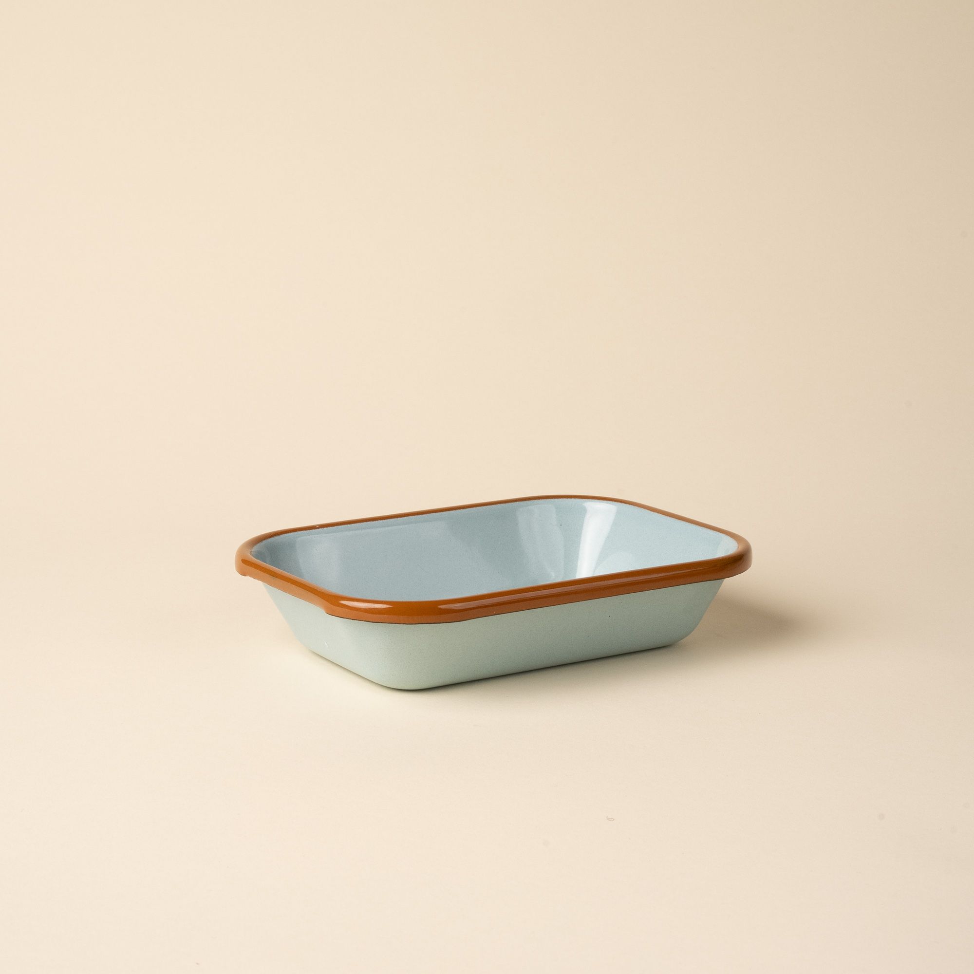 Small rectangular baking dish in a robin's egg blue color with a warm brown rim.