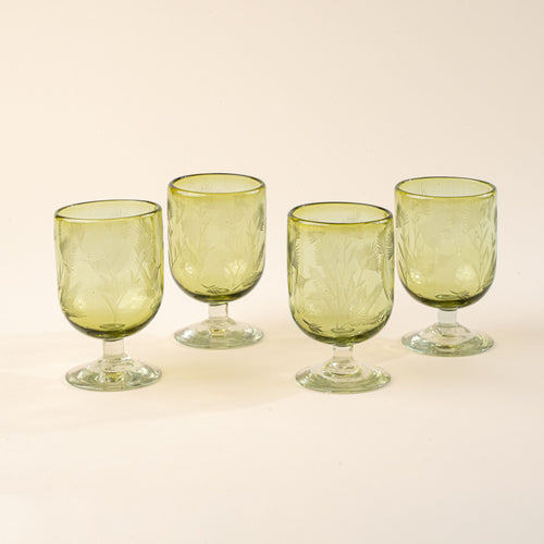 Four olive short wine glasses made of recycled glass with etched thistle designs on it