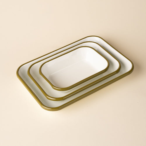 A nesting trio of small, medium, and large rectangular baking dishes in a white color with an olive green rim.