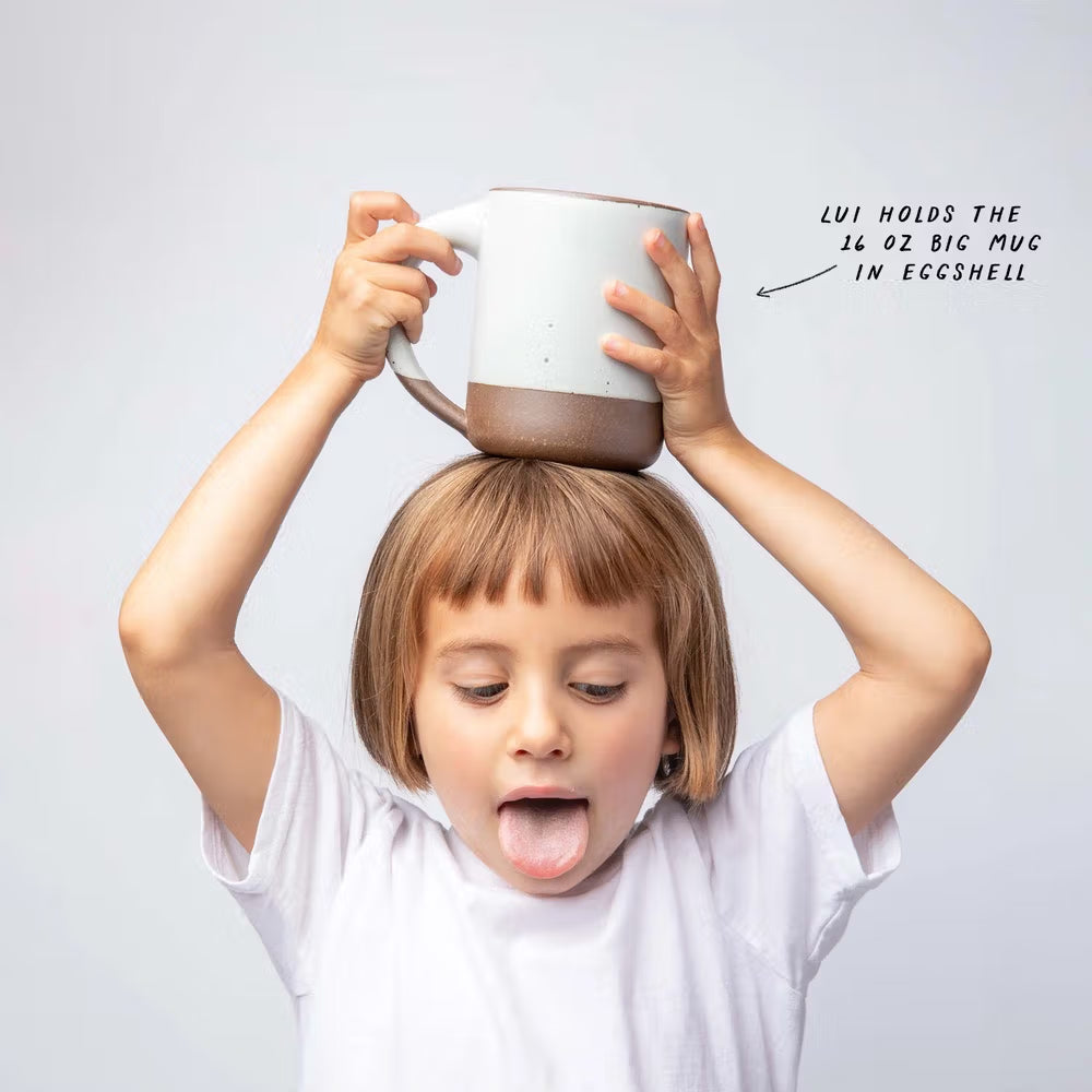 Lui holds the 16 oz Big Mug in Eggshell, on top of her head.