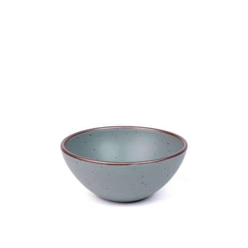A medium rounded ceramic bowl in a blue-grey color featuring iron speckles and an unglazed rim