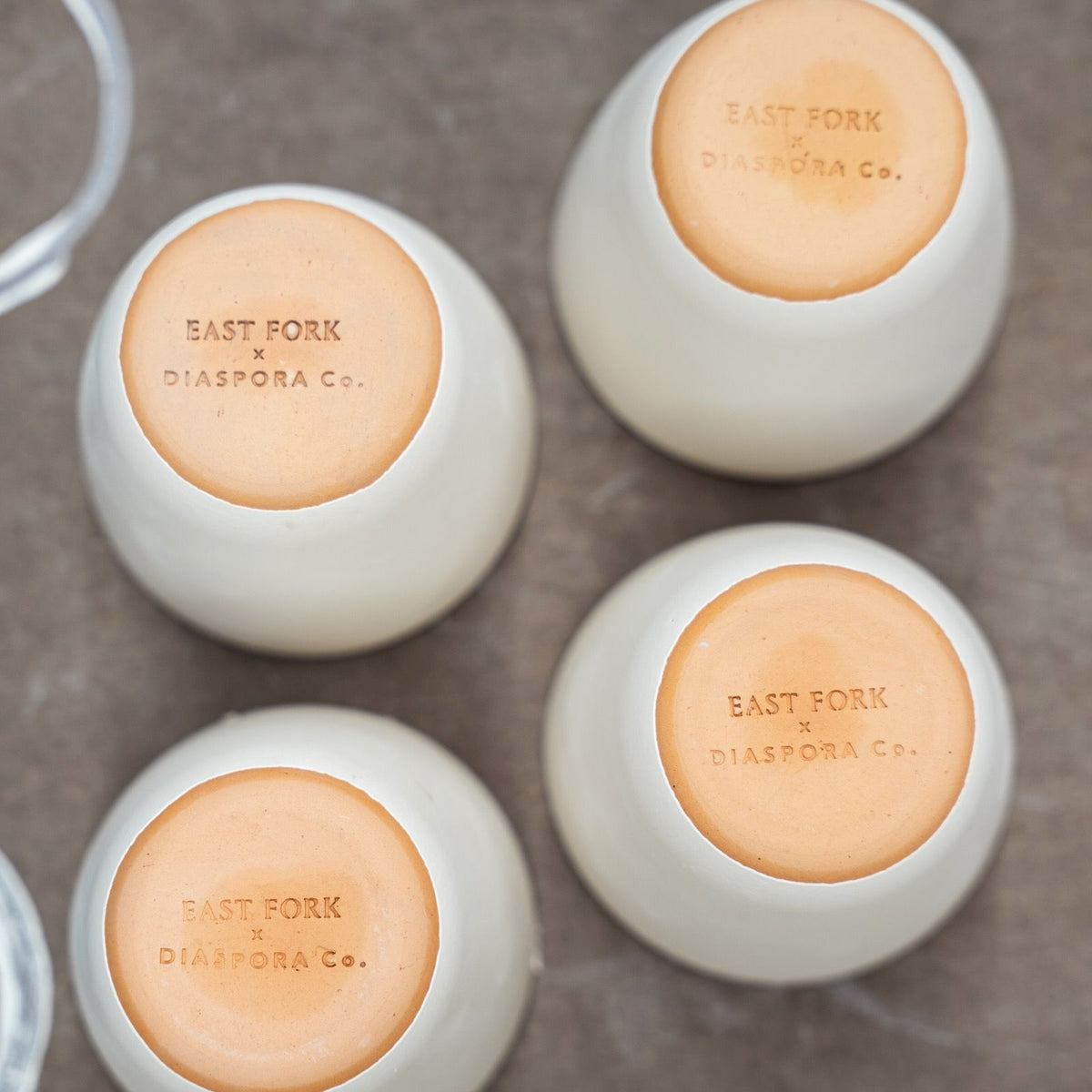 The bottom of The Kulhad showing an unglazed bottom with a stamp that reads 'EAST FORK x DIASPORA Co.'