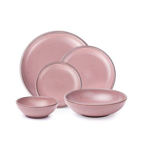 A breakfast bowl, everyday bowl, cake plate, side plate and dinner plate paired together in a dusty mauve pink color featuring iron speckles