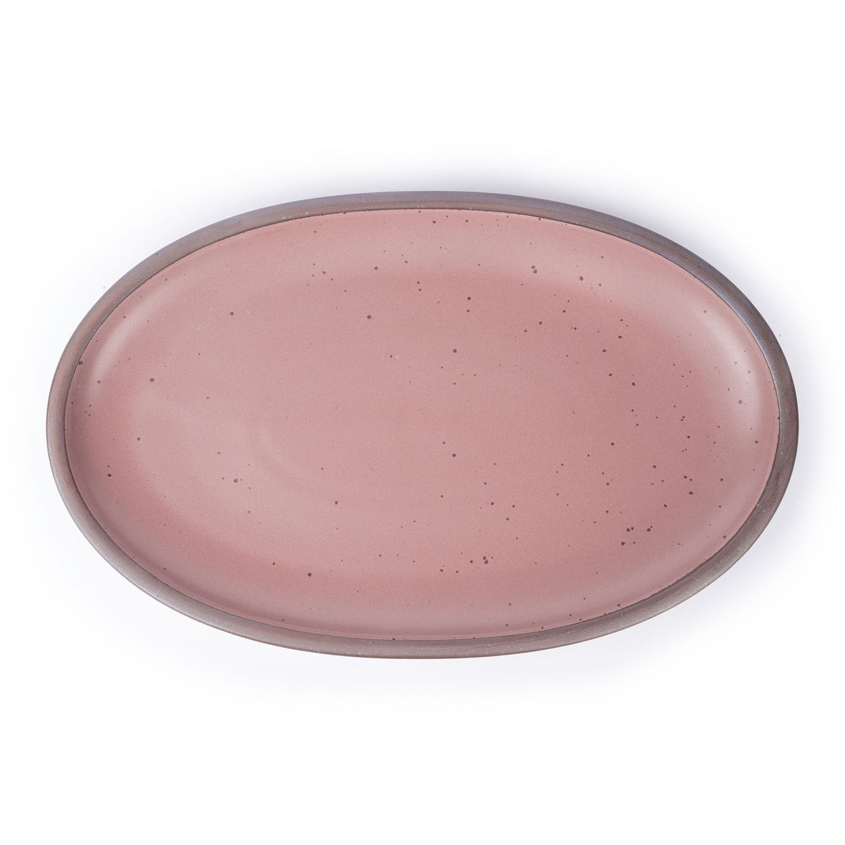 A large oval ceramic platter in a dusty mauve pink color featuring iron speckles and an unglazed rim