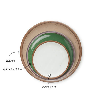 A stack of 3 plates in Dinner, Side, and Cake sizes in a warm pale brown, glossy emerald green, and cool white colors.