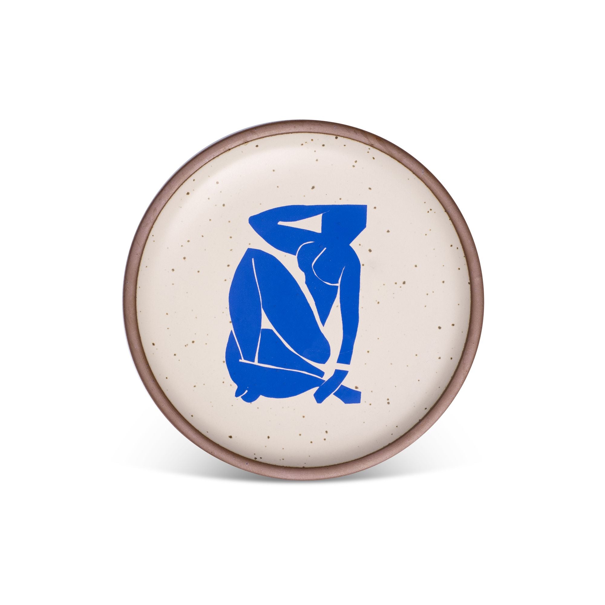A plate featuring Nu Bleu III, by Henri Matisse, a bright blue, abstract, silhouetted female figure in a curled, seated position, with sharp cut-out edges, centered on an off-white ceramic plate with an unglazed rim.