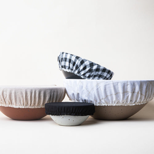 Mixing bowl, popcorn bowl, soup bowl, and ice cream bowl with linen bowl covers on them