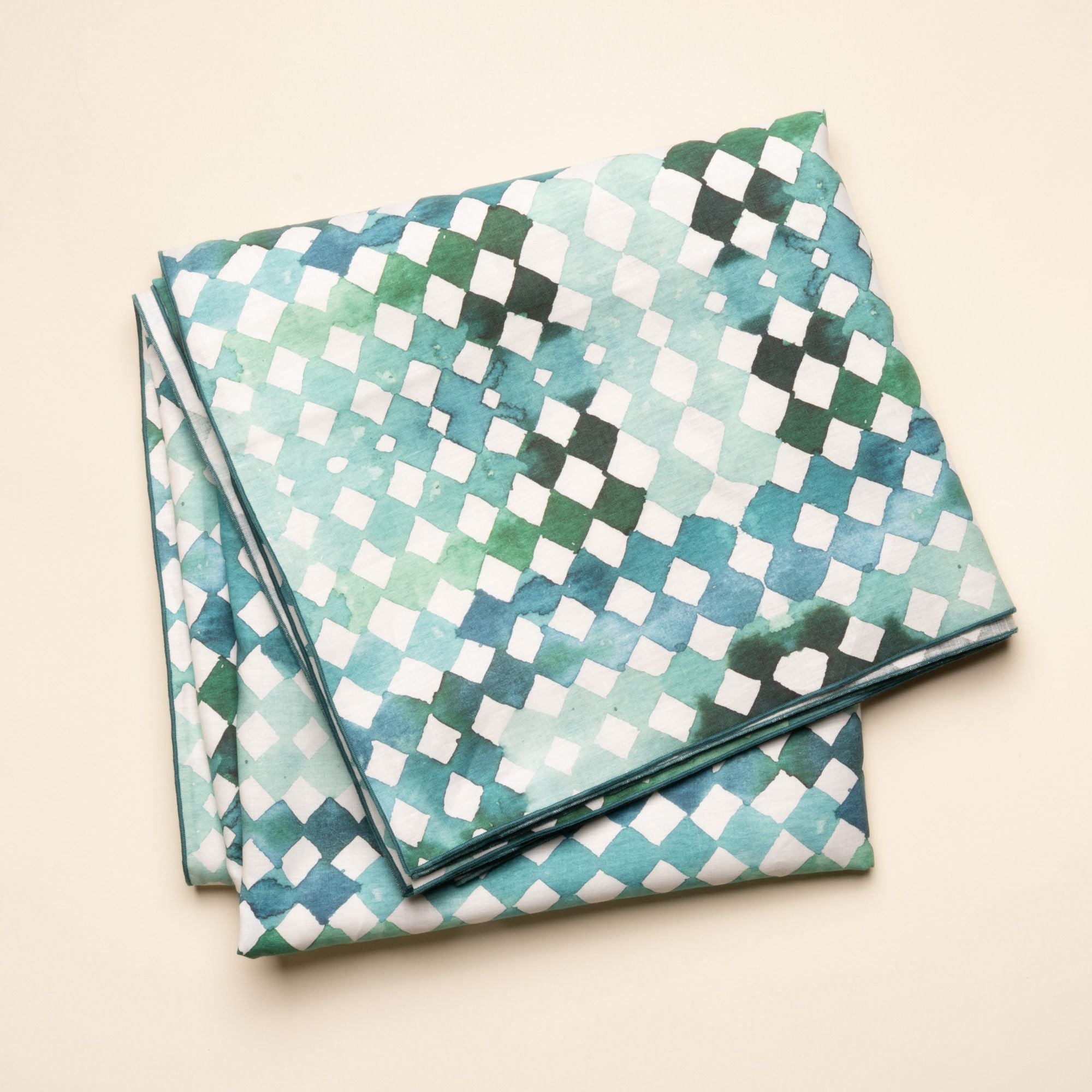 Watercolor diamond-patterned tablecloth in green and teal tones