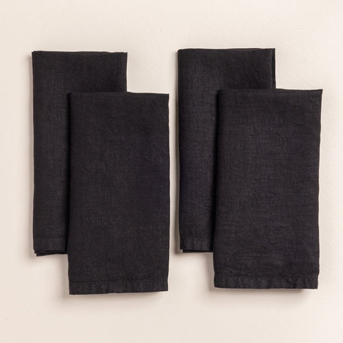 4 folded linen napkins in a black color