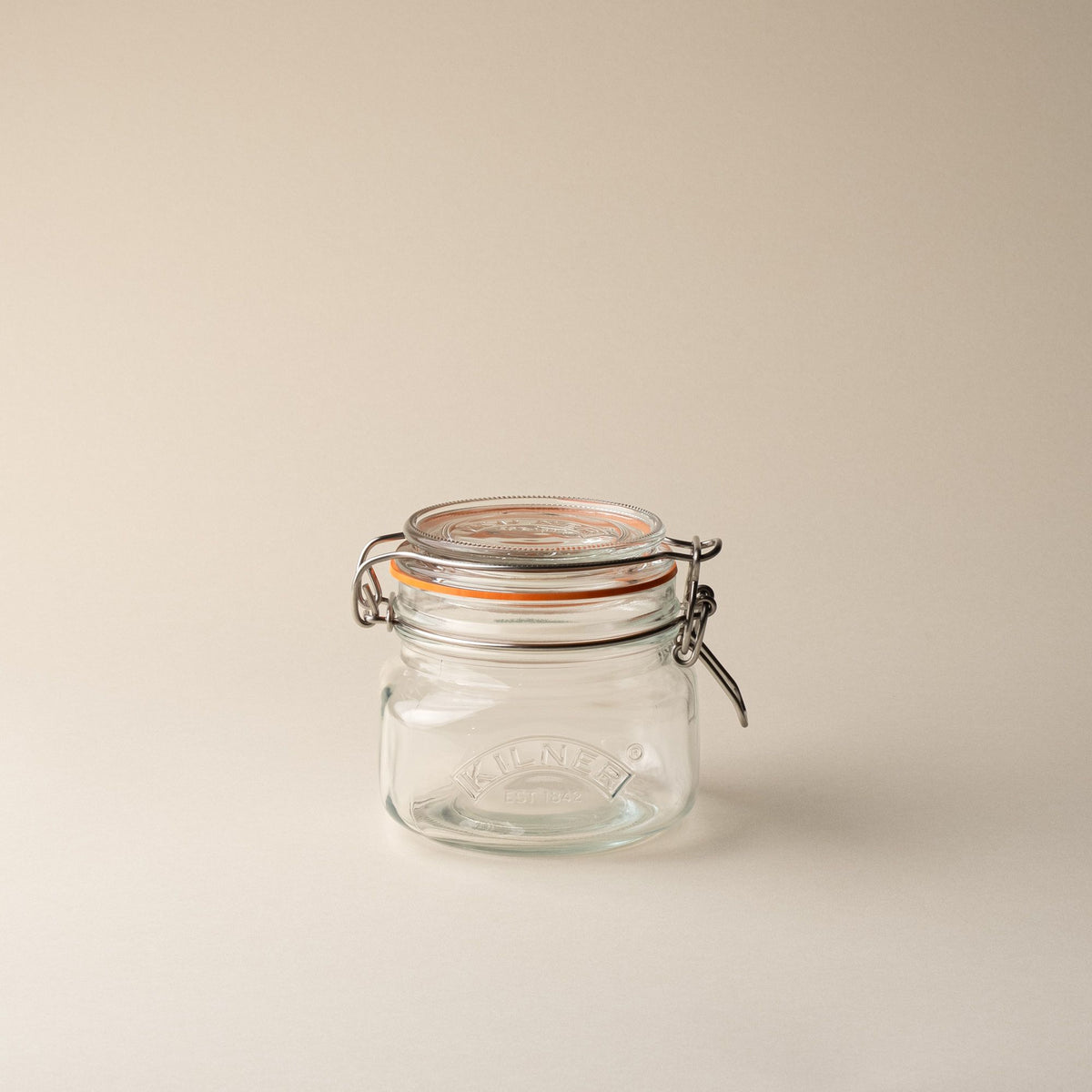 A shorter storage glass square jar, topped with a lid with a rubber seal and steel clip closure.