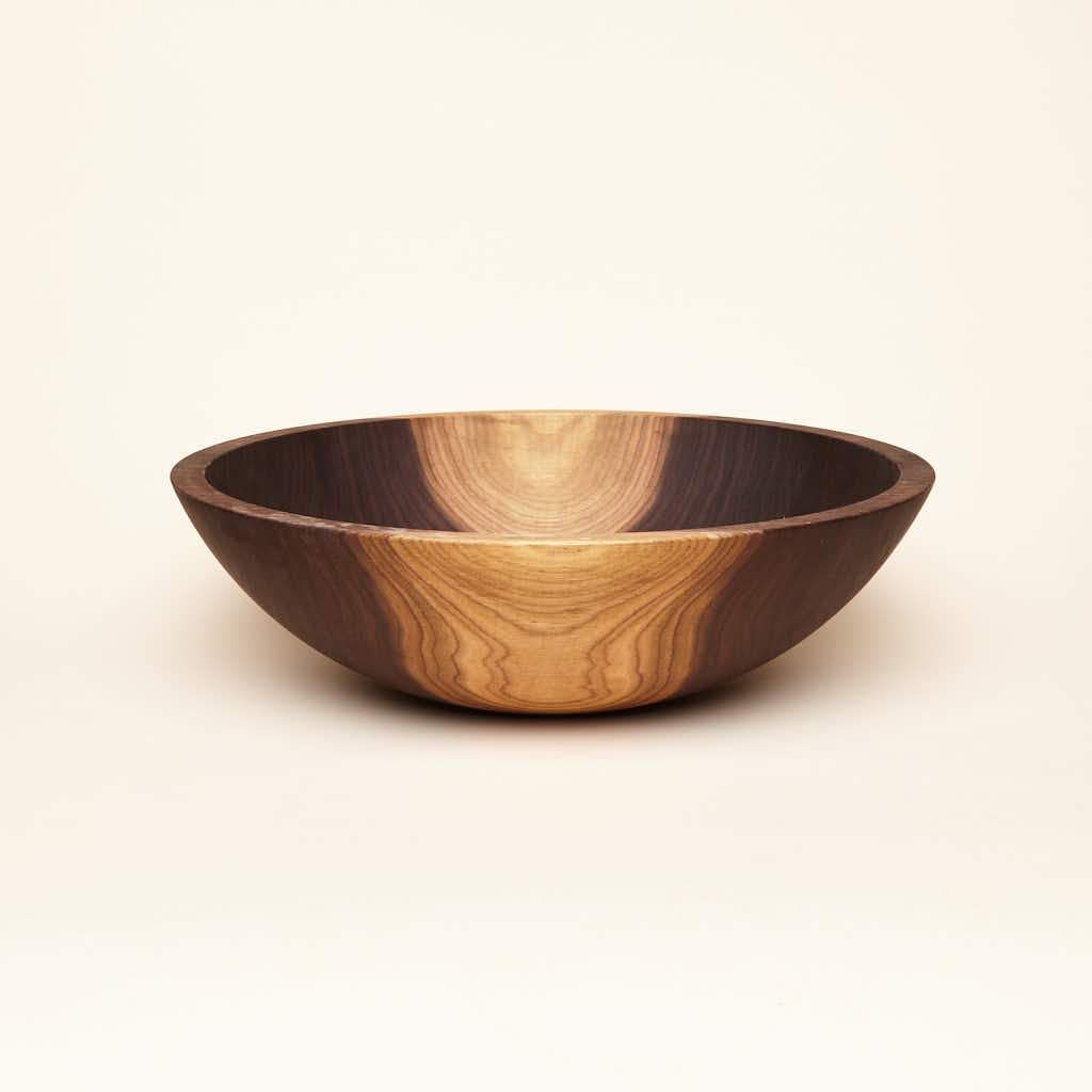 A large-sized walnut wood bowl with some maplewood color in the wood