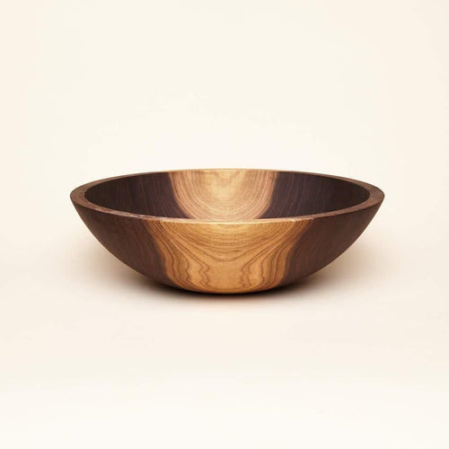 A large-sized walnut wood bowl with some maplewood color in the wood