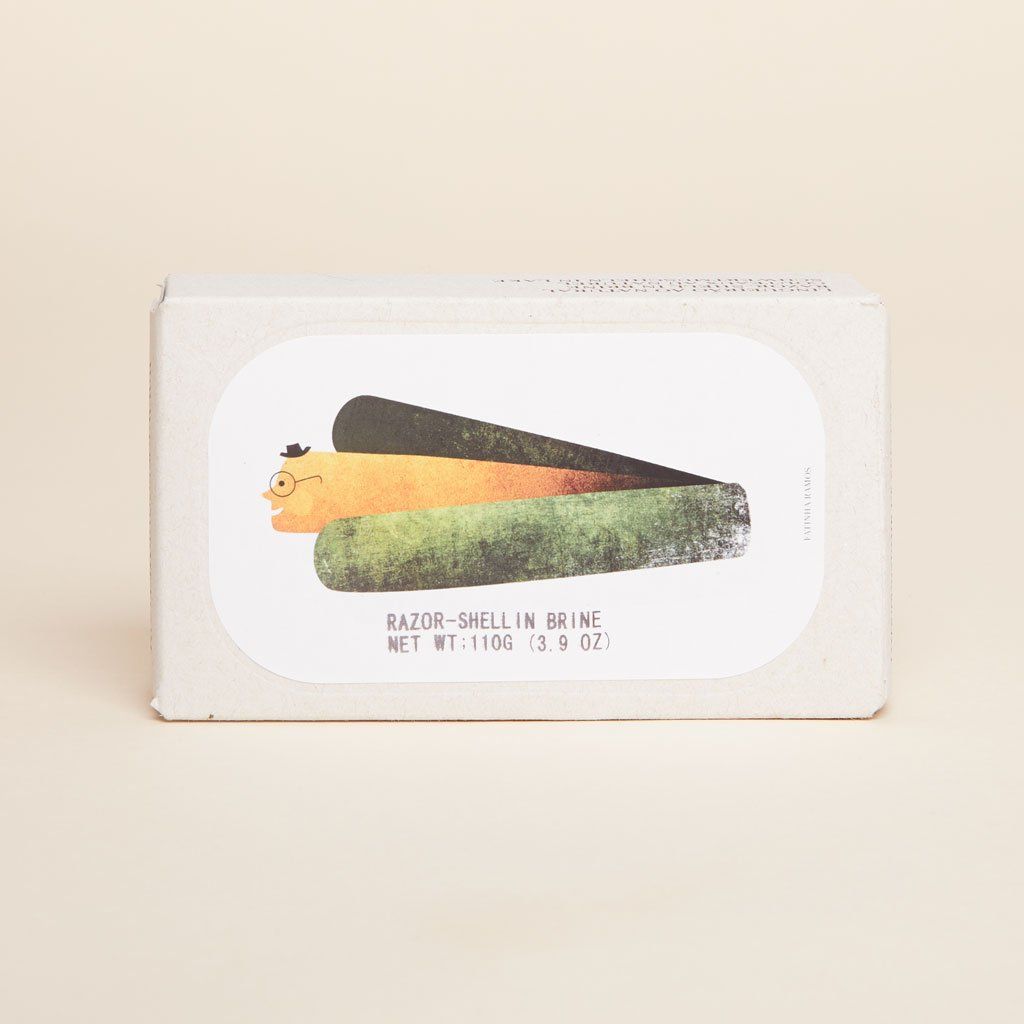 A light brown rectangular box with a white label that says, "Razor-Shell in Brine" and shows a whimsical illustration of a razor-shell clam with a little hat and glasses emerging from its shell