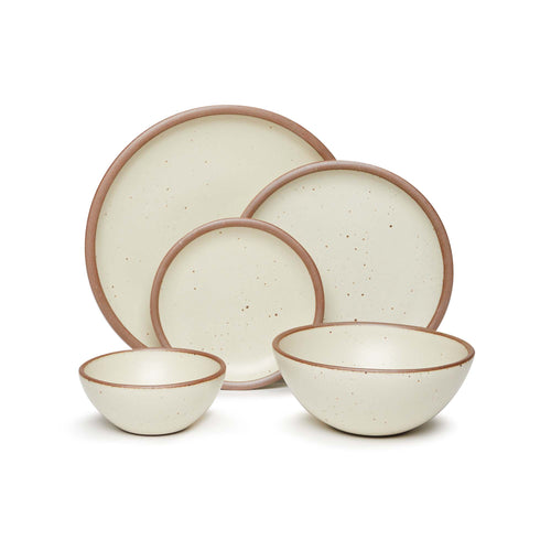 An ice cream bowl, soup bowl, cake plate, side plate and dinner plate paired together in a warm, tan-toned, off-white featuring iron speckles