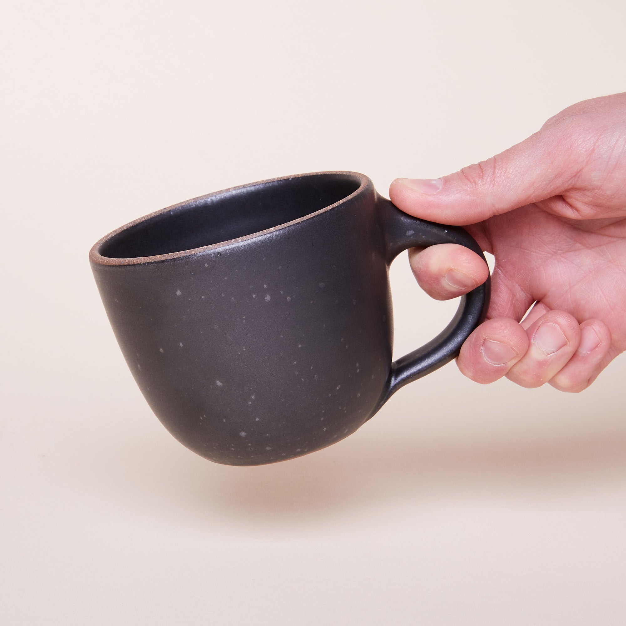 Hand holding Sunday Morning Mug in Black Mountain
