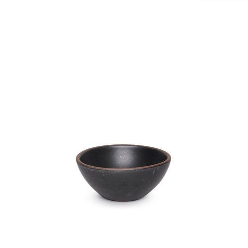 A small dessert sized rounded ceramic bowl in a graphite black color featuring iron speckles and an unglazed rim